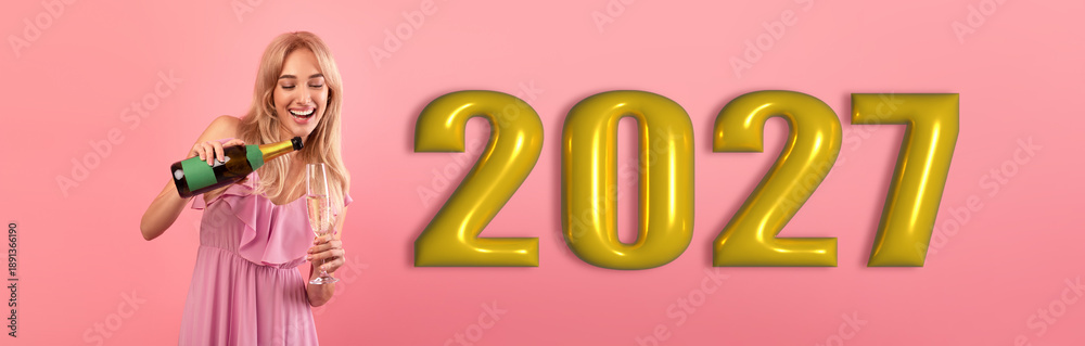 Obraz premium A person pours a drink while celebrating the new year 2027. The background is pink with large gold numbers showing the year. The mood is joyful and festive.