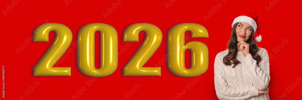 Obraz premium A woman wearing a santa hat thinks about the year 2026 in a set with large golden numbers against a red background. The collage presents a festive and imaginative mood during the holidays.