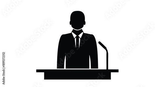 Silhouette of a businessman standing confidently at a podium with microphone giving a public speech or presentation