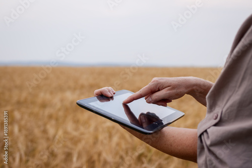 Tableau sur toile Farmer using modern technology for smart farming