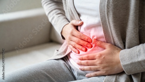 Woman suffering from lower abdominal pain at home