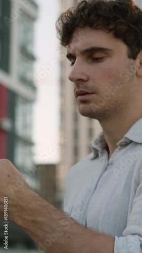 Thinking Caucasian business man with mobile phone think in city downtown pondering puzzled businessman hesitate guy male employer deciding solution holding smartphone ponder idea unsure with internet