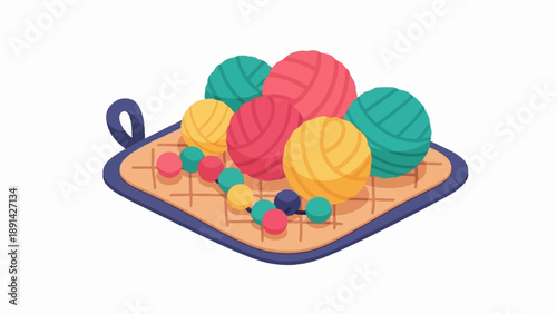 Colorful yarn balls and beads arranged on a patterned surface with a loop handle