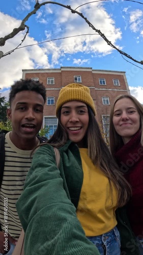 Diverse friends taking selfie video outside university