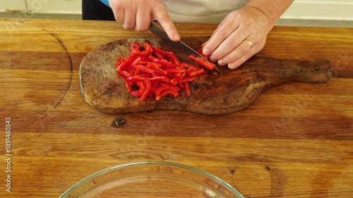 Woman cutting red pepper for salad
