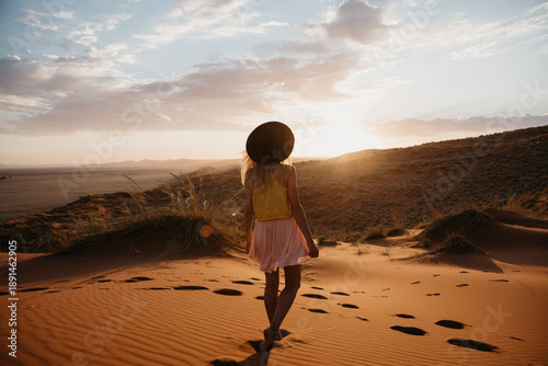 Namibia, Namib desert, Namib-Naukluft National Park, Sossusvlei, woman walking on Elim Dune at sunset