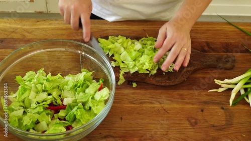 Woman cutting iceberg lettuce for salad
