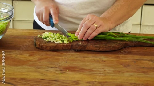 Woman cutting iceberg lettuce for salad
