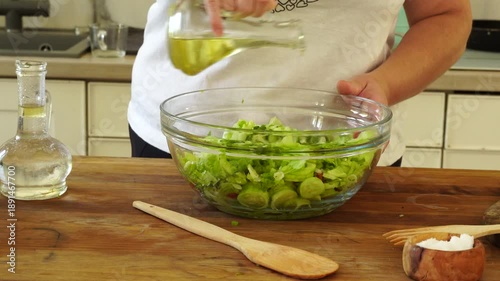Woman cutting iceberg lettuce for salad
