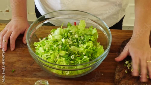 Woman cutting iceberg lettuce for salad
