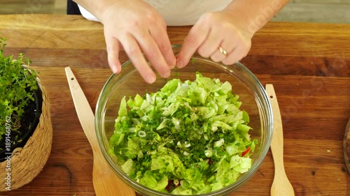 Woman cutting iceberg lettuce for salad
