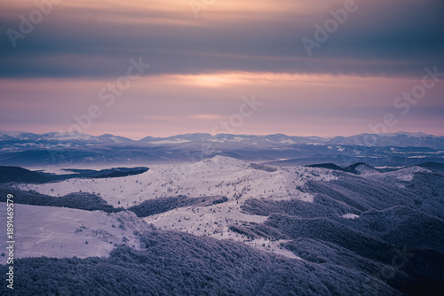 Εκτύπωση καμβά Winter mountain landscape during blue hour sunrise with snowy ridges and distant peaks of the Bieszczady Mountains, seen from Tarnica during frosty trekking conditions