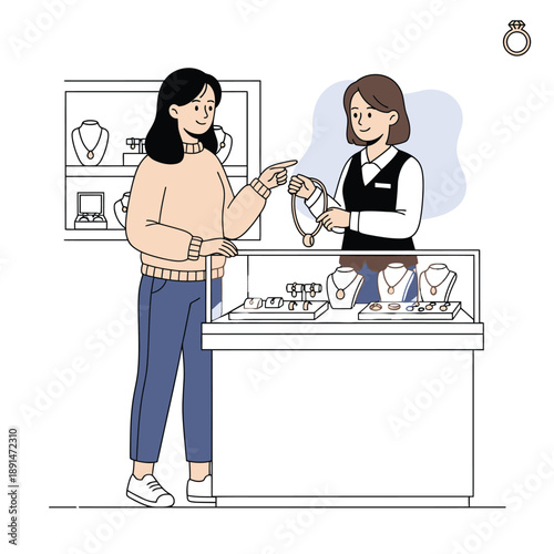 Customer pointing at a gold necklace being shown by a sales assistant in a jewelry store.