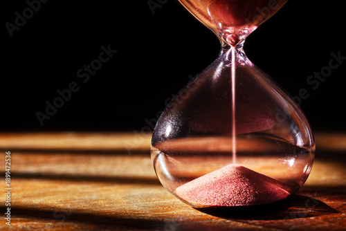 Billede på lærred Hourglass time passing background concept for business deadline, urgency and run