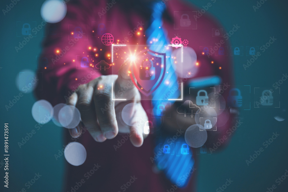 Obraz premium Businessman Activating a Digital Cyber Security Shield for Data Privacy Protection.
