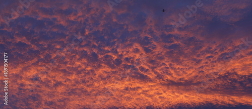 Commercial Airplane flies into a beautiful evening sea of clouds