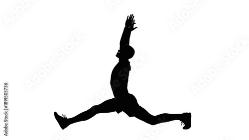 Silhouette of a man performing a dynamic split jump exercise.