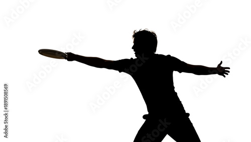 Silhouette of a man throwing a frisbee with outstretched arms.