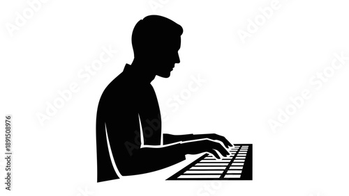 Silhouette of a man typing on a computer keyboard.