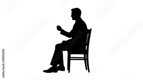 Silhouette of a Man Sitting on a Chair in Profile.