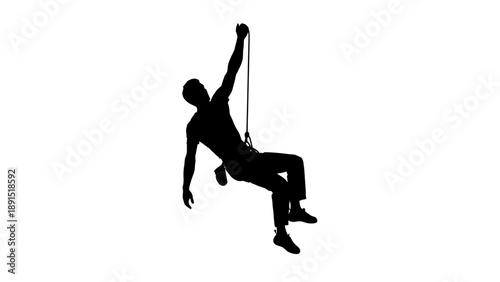 Silhouette of a man rappelling down a rope.