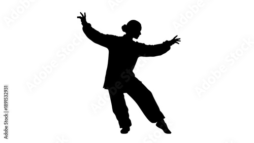 Silhouette of a woman practicing Tai Chi movements in studio.