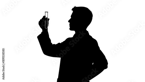 Silhouette of scientist examining test tube in laboratory.