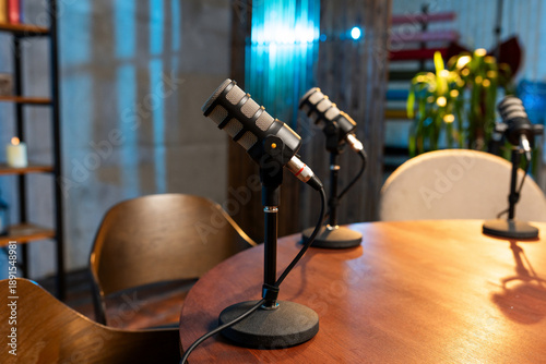 Podcast setup with microphones ready for discussion at a studio in the evening