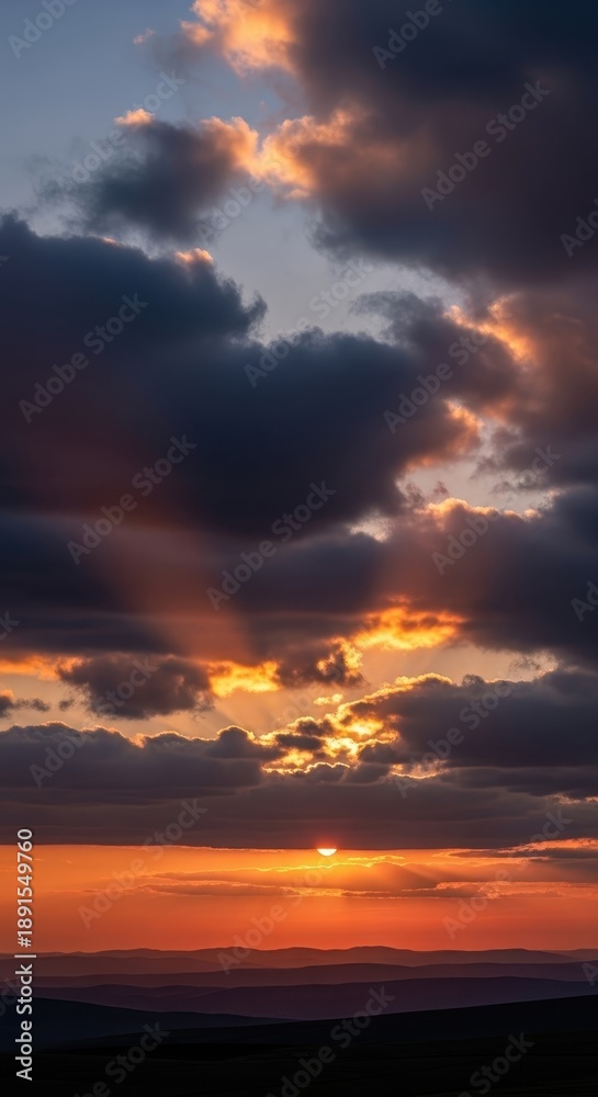 Fototapeta premium Dramatic Cloudscape at Sunset - A Symphony of Light and Shadow.