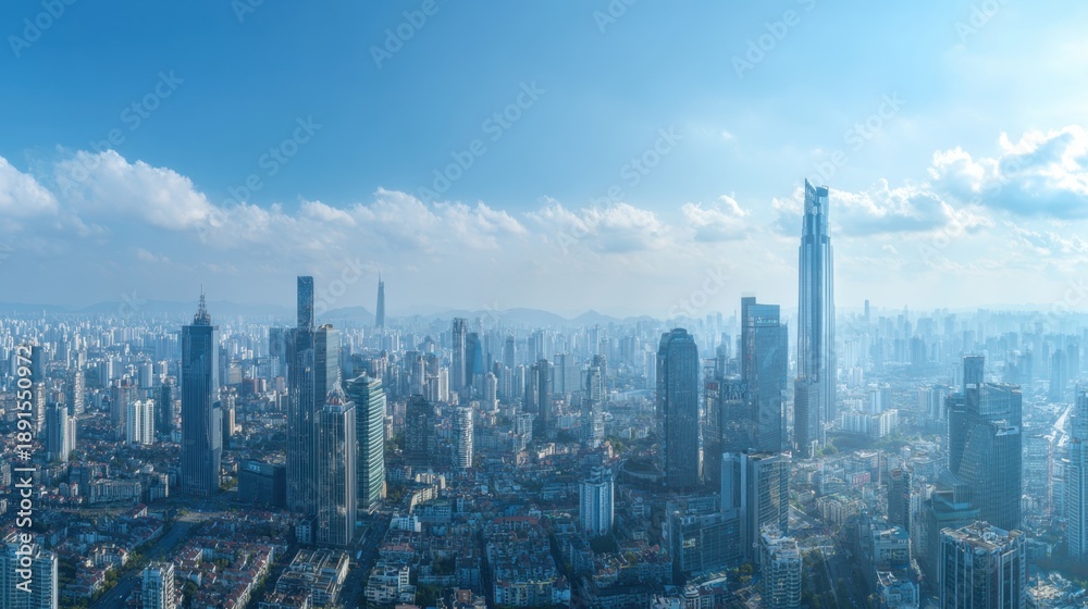 Naklejka premium Panoramic skyline view of modern urban cityscape against blue sky.