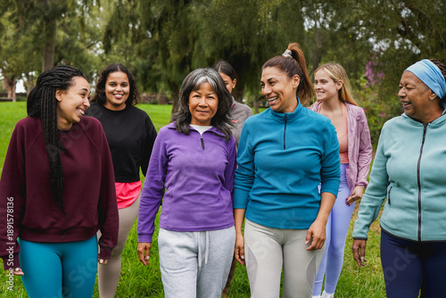 Group of multiracial women with different age and body walking together at city park - Multi generational people, sport training and female community concept
