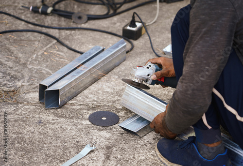 Wallpaper Mural Hand of Construction builder worker polishing with grinder to iron bar on the concrete floor at work area. Preparation for painting on construction site. Home renovation. Torontodigital.ca