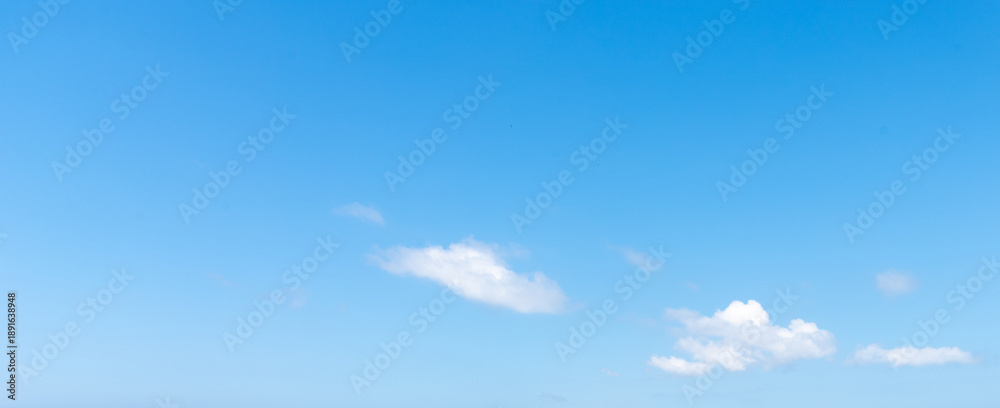 Fototapeta premium Blue Sky Background with White Clouds on Right Side and Wide Copy Space