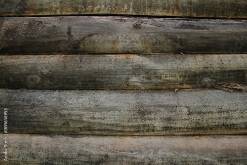 beautiful natural wooden logs stacked in a row	
