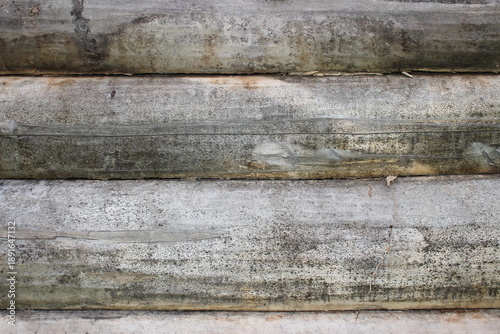 beautiful natural wooden logs stacked in a row	
