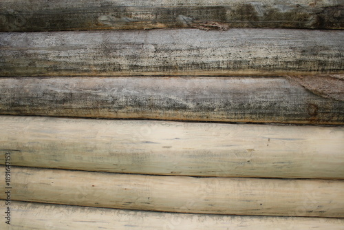 beautiful natural wooden logs stacked in a row	
