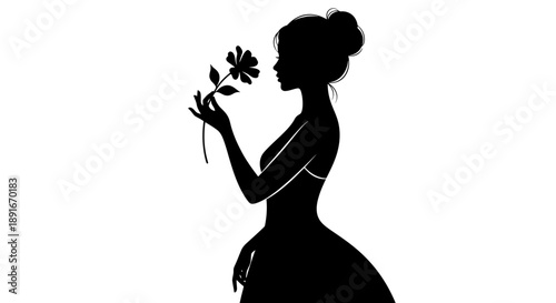 A silhouette of a woman gently smelling a single flower
