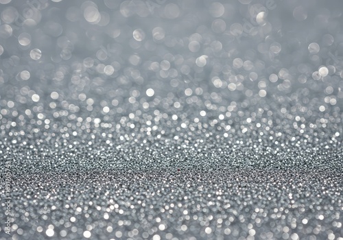 Abstract texture of delicate fine silver glitter sparkling brightly under diffuse light, creating a perfect celebratory holiday background or festive overlay ,macro ,design ,glowing