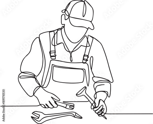 Man working on metal piece with wrench and tool in workshop