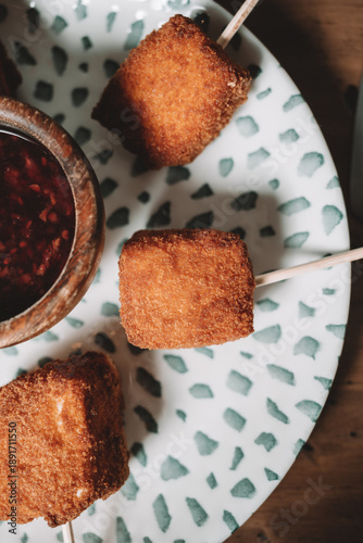 Fried breaded snack cubes served with dipping sauce