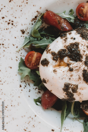 Fresh burrata cheese with arugula and cherry tomatoes