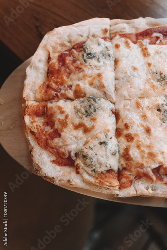 Cheese pizza slices served on wooden board
