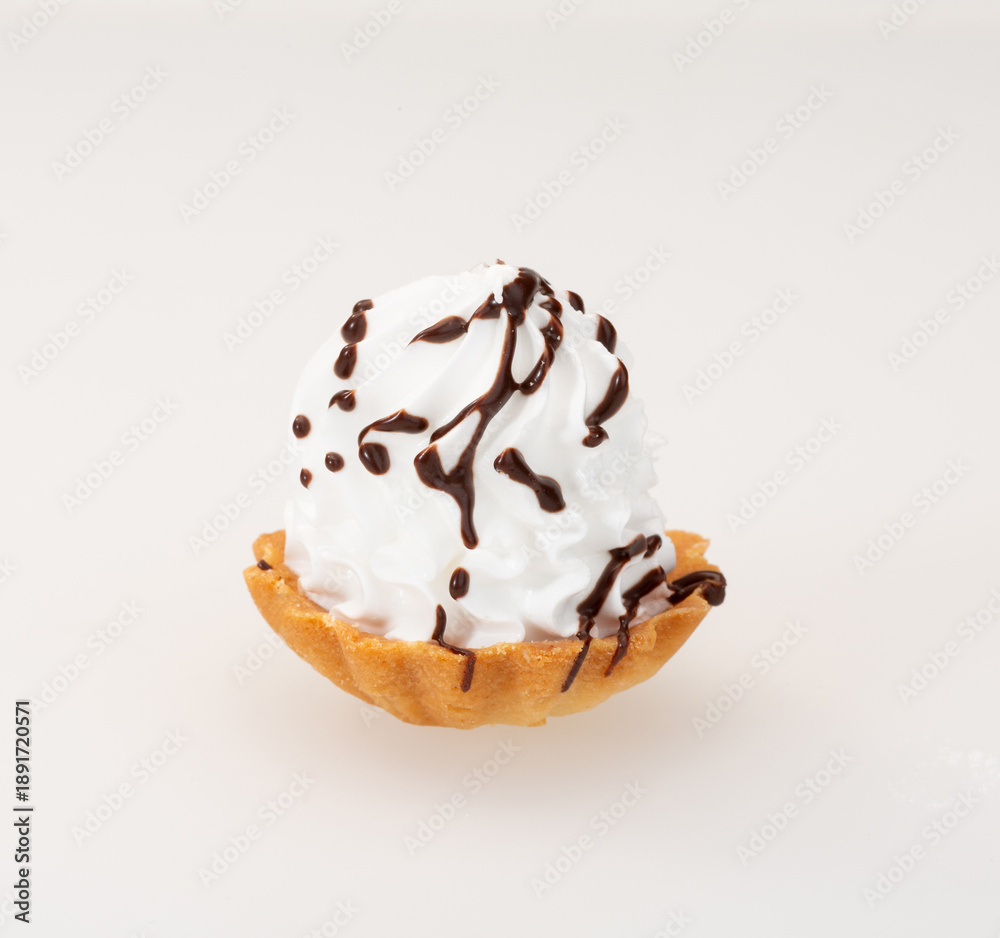 Fototapeta premium Delicious dessert basket with whipped cream and chocolate syrup