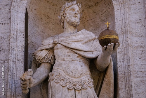 Close up of a statue of the mighty king Charlemagne holding a sword and globus cruciger 