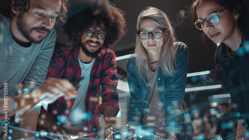Young professionals work together on a digital project in a modern office at night to share ideas and develop solutions