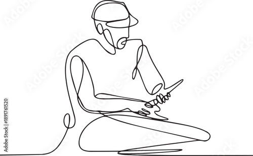 Man sitting cross-legged playing guitar on floor in relaxed pose