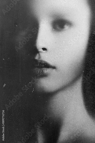 Young woman's ethereal face emerging from shadows, evoking mystery and melancholy