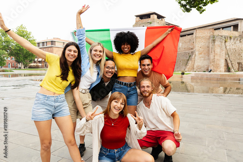 Italian community smiling together with national flag. Diverse young people sharing pride and belonging in their country. Unity and culture concept.