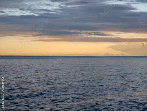 Idyllic sunset scene showcasing smooth ocean surf and warm glowing light inviting calmness and comfort