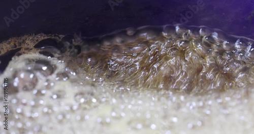Melted sugar dissolved in water boiling, making syrup for oriental cakes like baklava